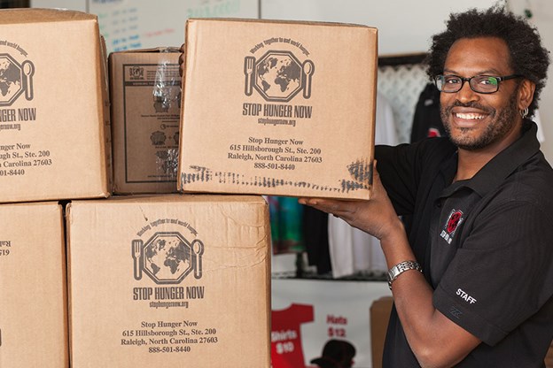 PULSE Volunteer working with boxes 