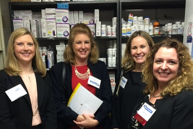 4 happy women with paperwork in front a gsk products